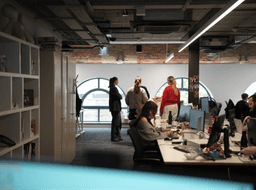 Team members gathered in a contemporary Johannesburg office with industrial ceilings and large windows.