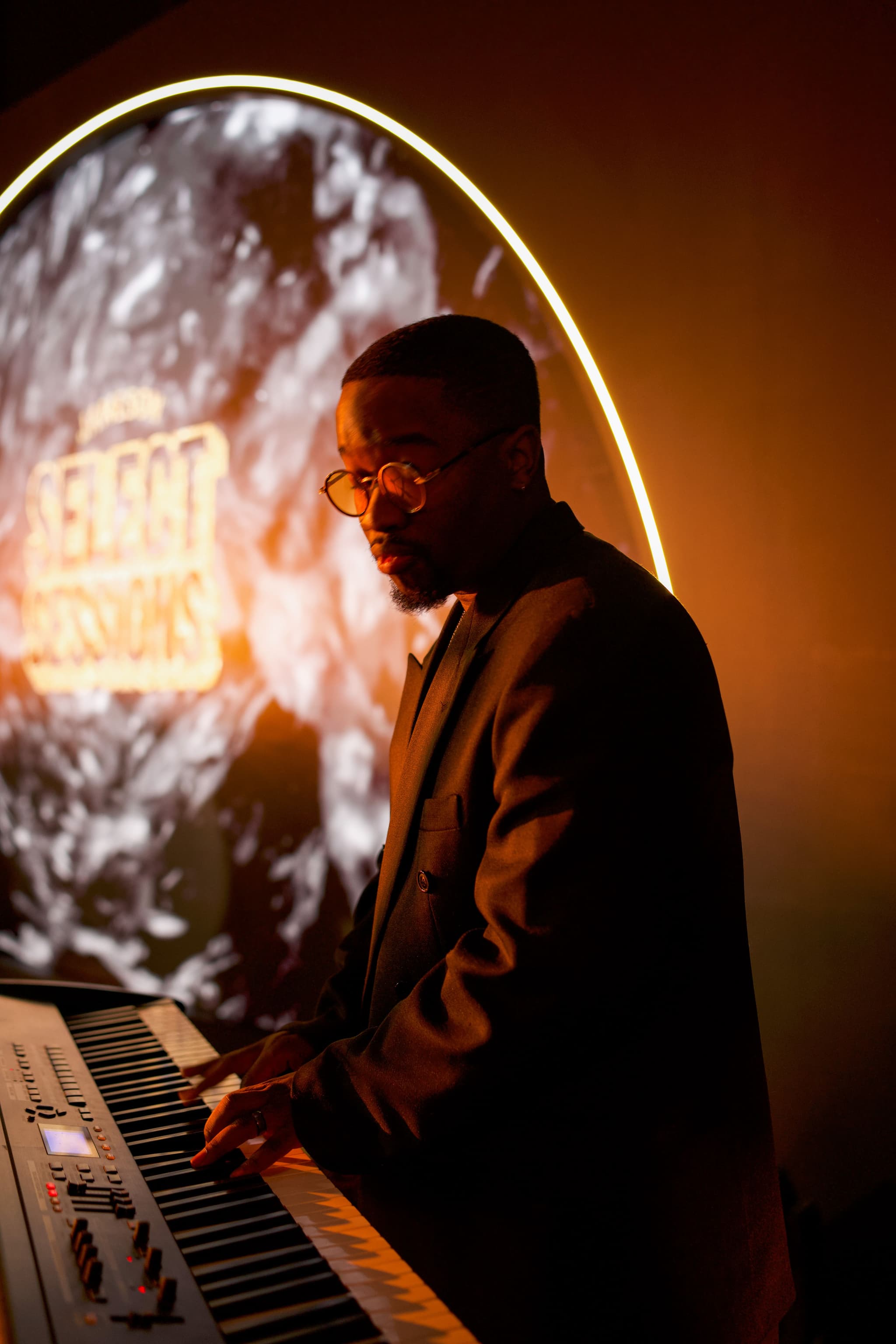 Male musician wearing glasses playing a keyboard at a Jameson Select Sessions live music event.