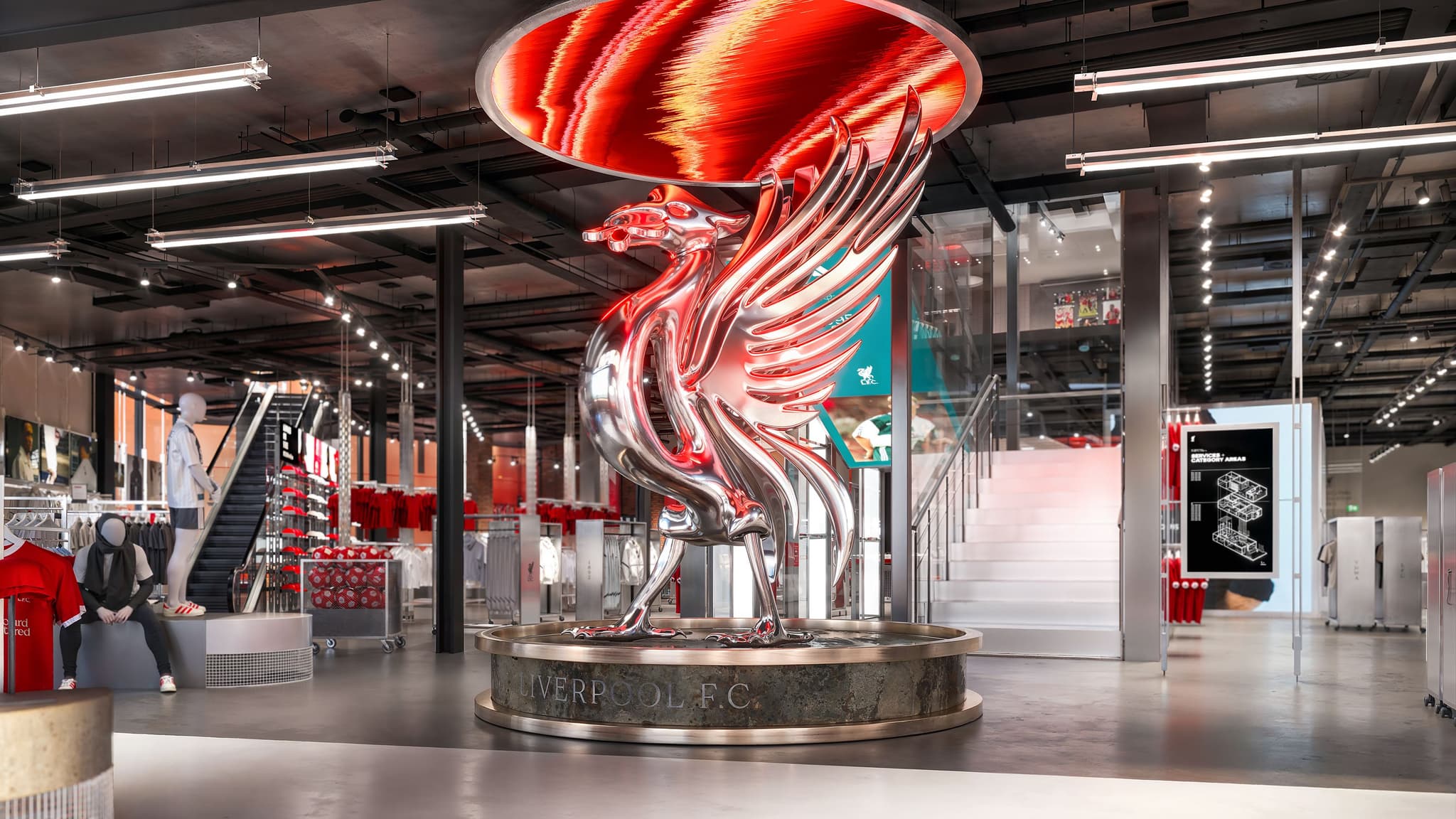 Large metallic silver Liverbird statue on a stone Liverpool F.C. plinth in the center of the club store.