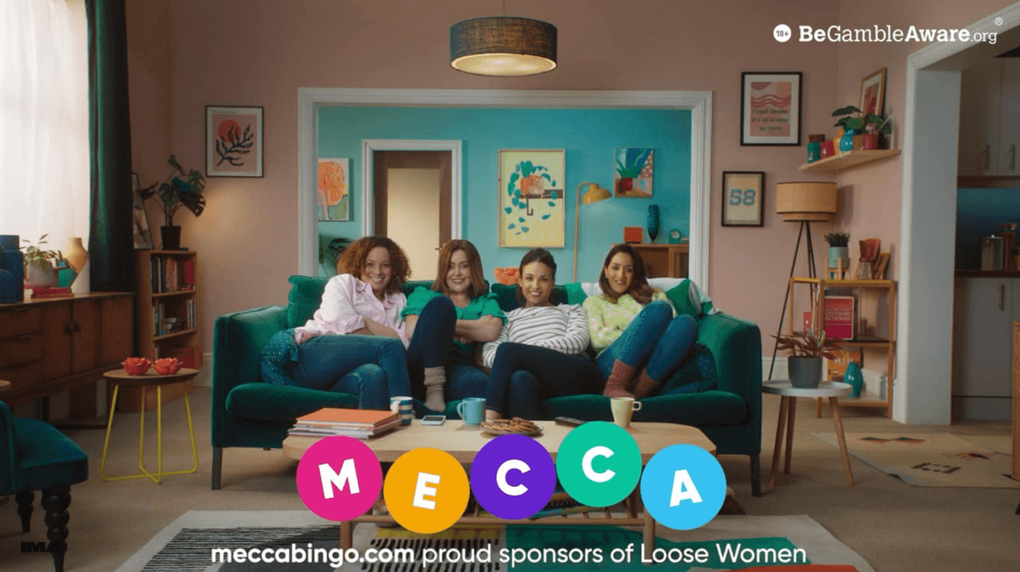 Four women relaxing on a green sofa in a living room for a Mecca Bingo Loose Women sponsorship advert.