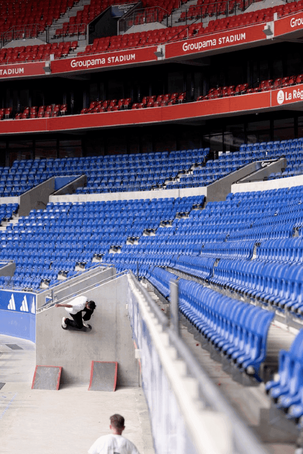 Vertical view of rows of empty blue stadium seats.