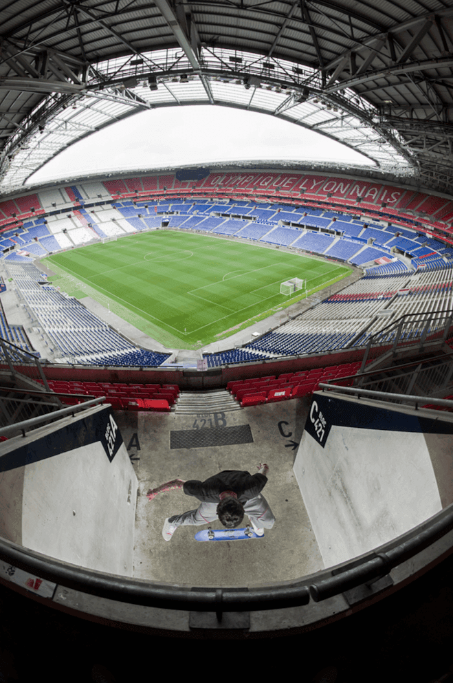 Wide-angle view of a modern sports stadium interior with a red and blue color scheme.