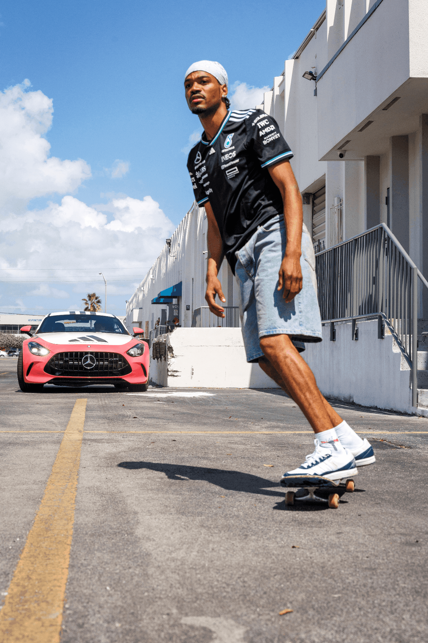 Pro skater Tyshawn Jones skateboarding past a Mercedes-AMG car during the Miami Grand Prix activation.