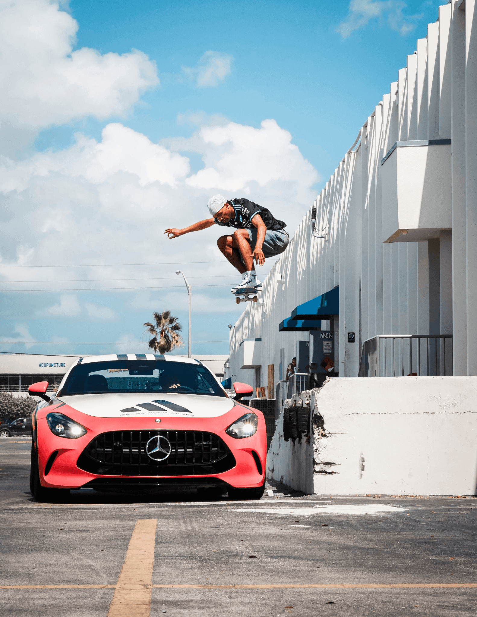 Tyshawn Jones jumping over the front of a Mercedes-AMG F1 car in an Adidas collaboration.