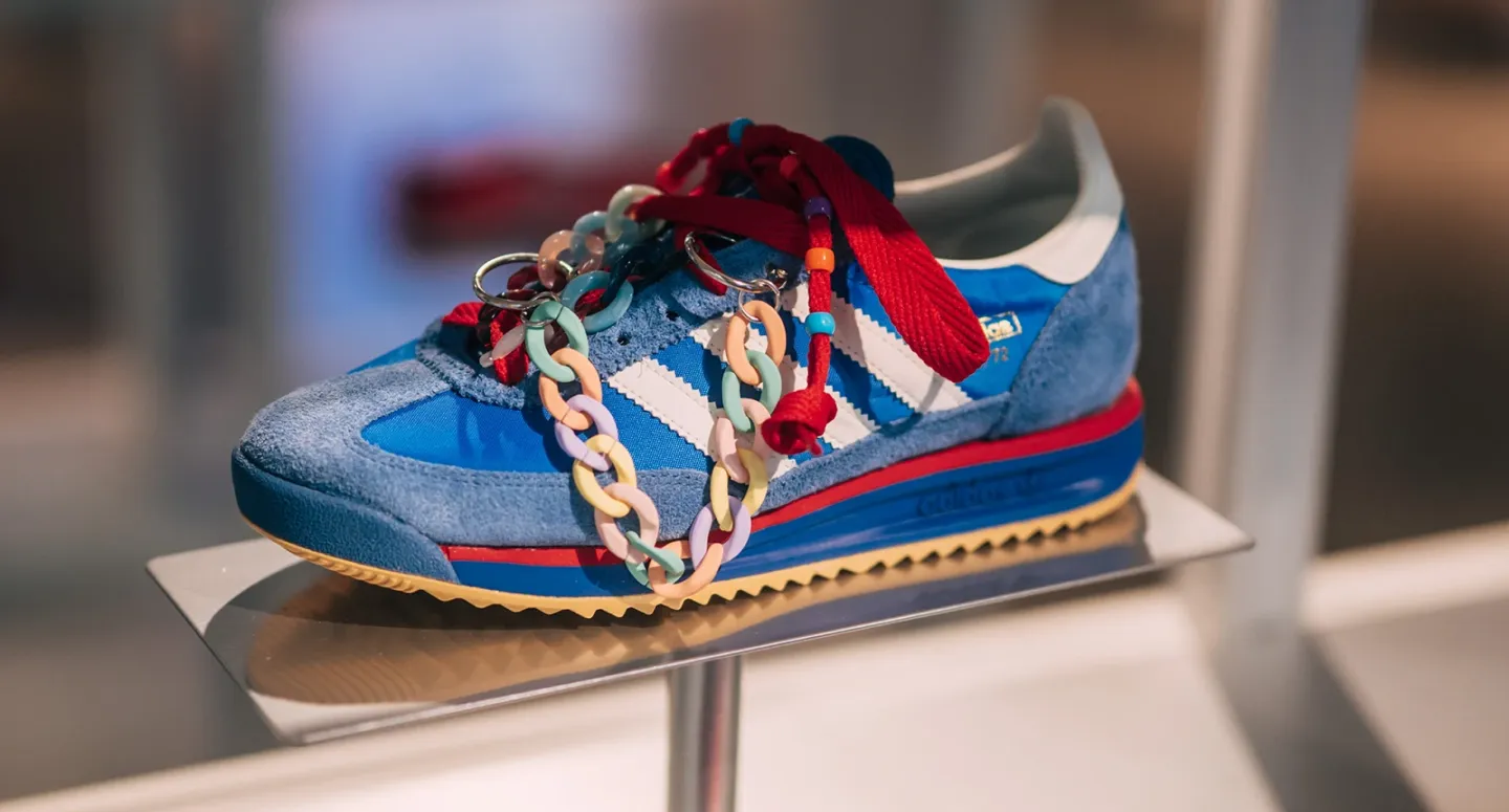 Blue Adidas SL 72 sneaker displayed on a shelf featuring colorful plastic chain links and bead customization.