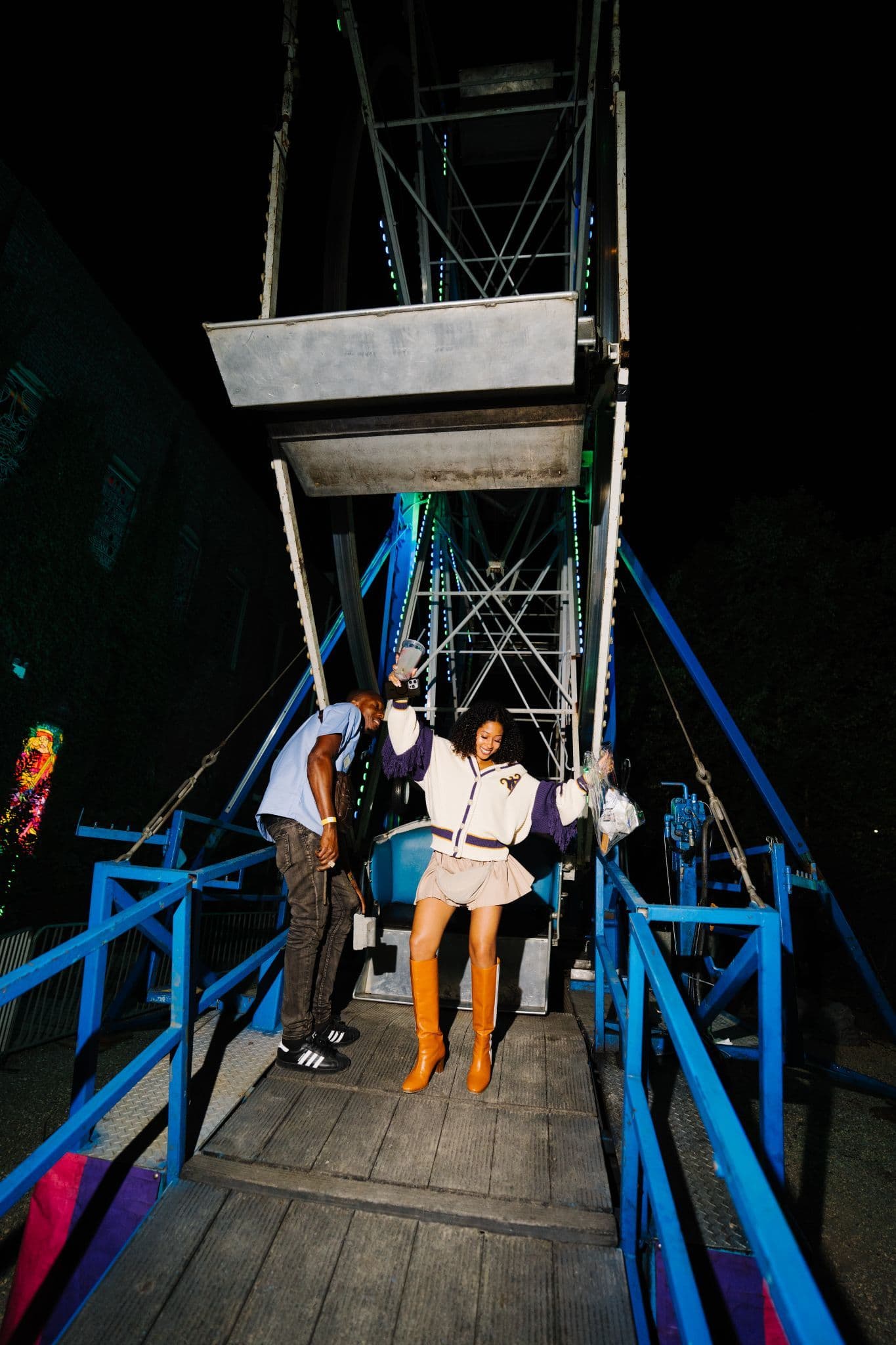 Attendees posing on a carnival ride at the Adiland fashion week activation.