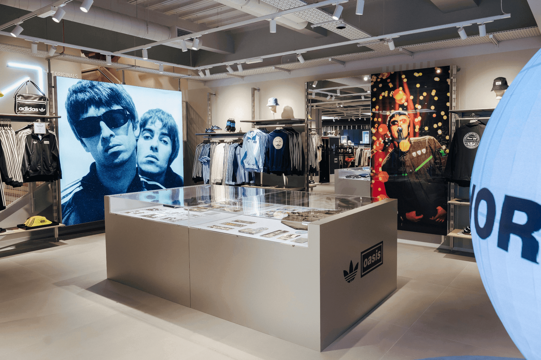 A retail counter featuring Liam Gallagher photography and a display of vintage apparel.