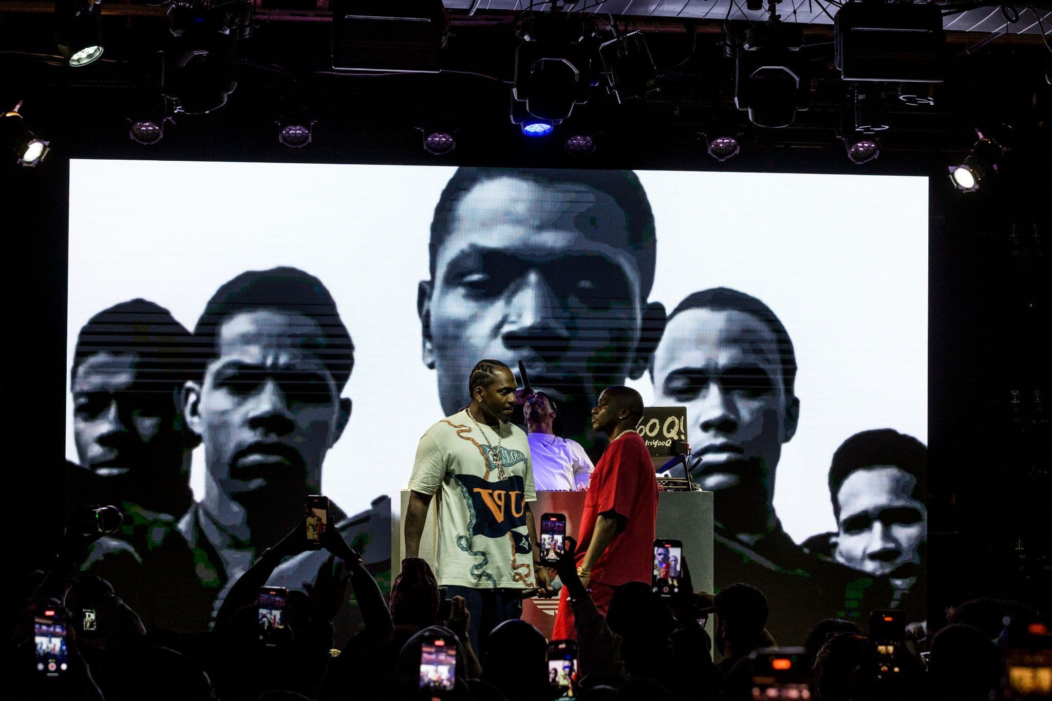 Live musical performance on stage with large digital screens at the adidas Adiland festival.