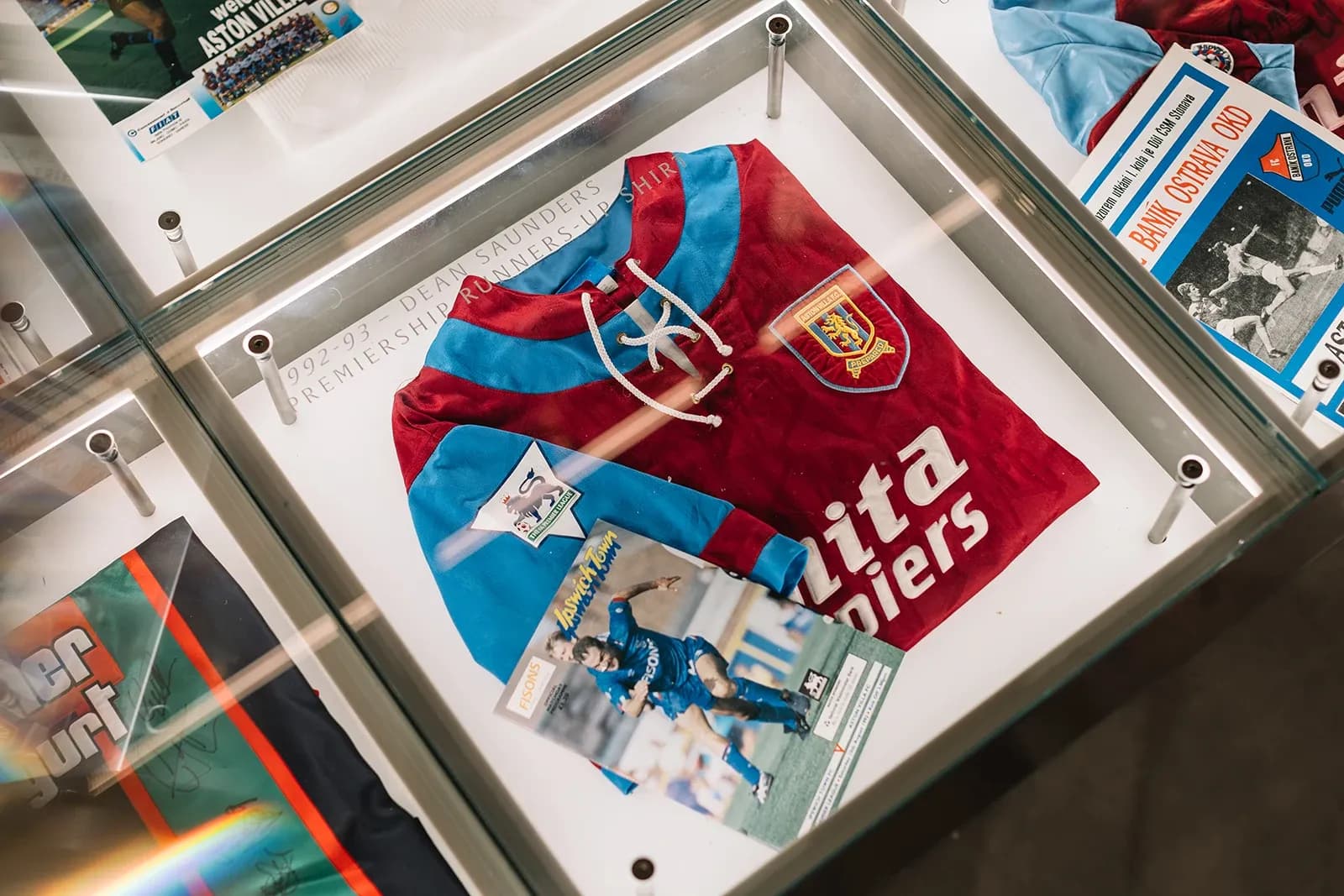 Display case featuring Dean Saunders' 1992-93 Premiership Runners-Up shirt with Mita Copiers sponsor.