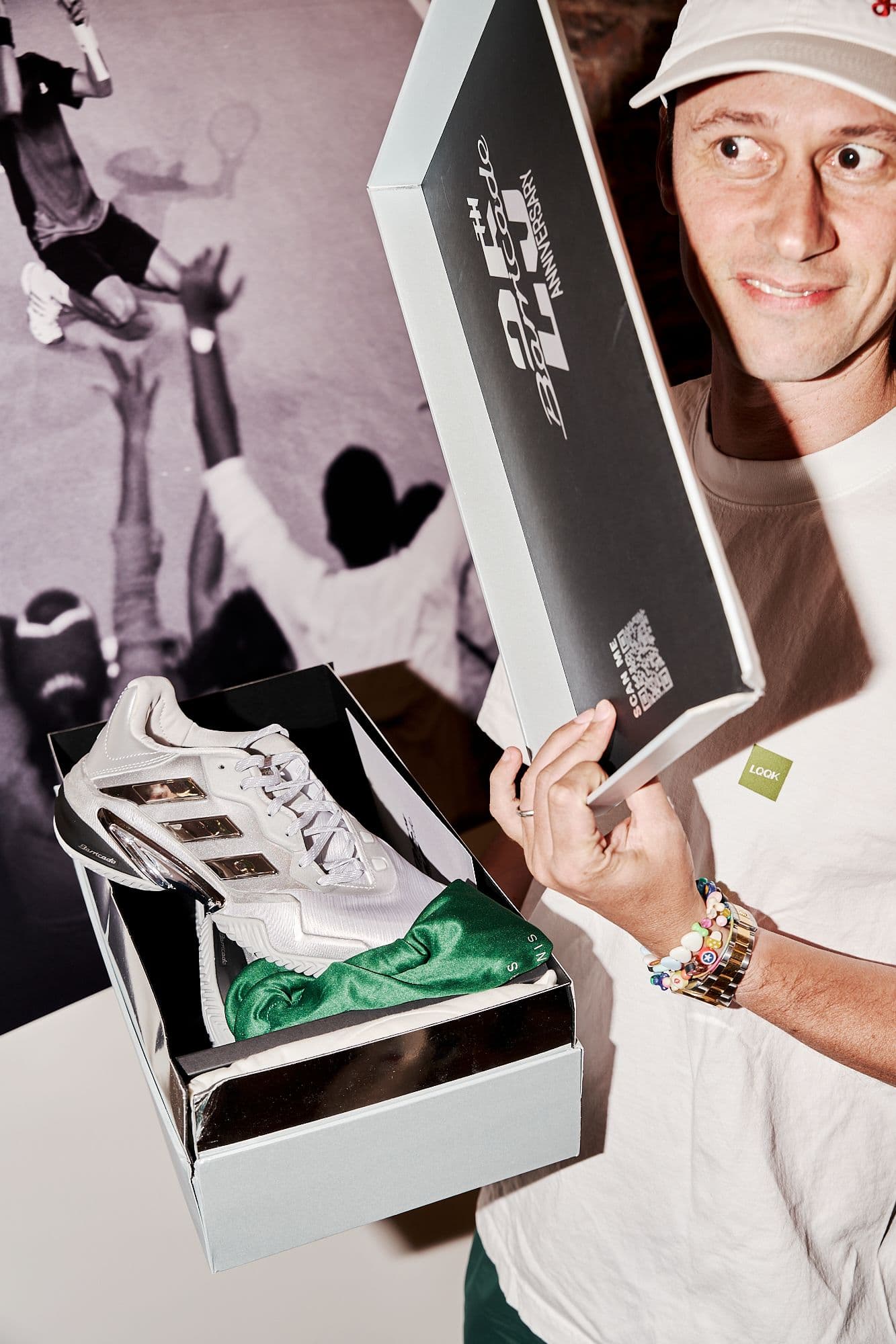 A person holding a physical copy of Barricade product history and legacy imagery.