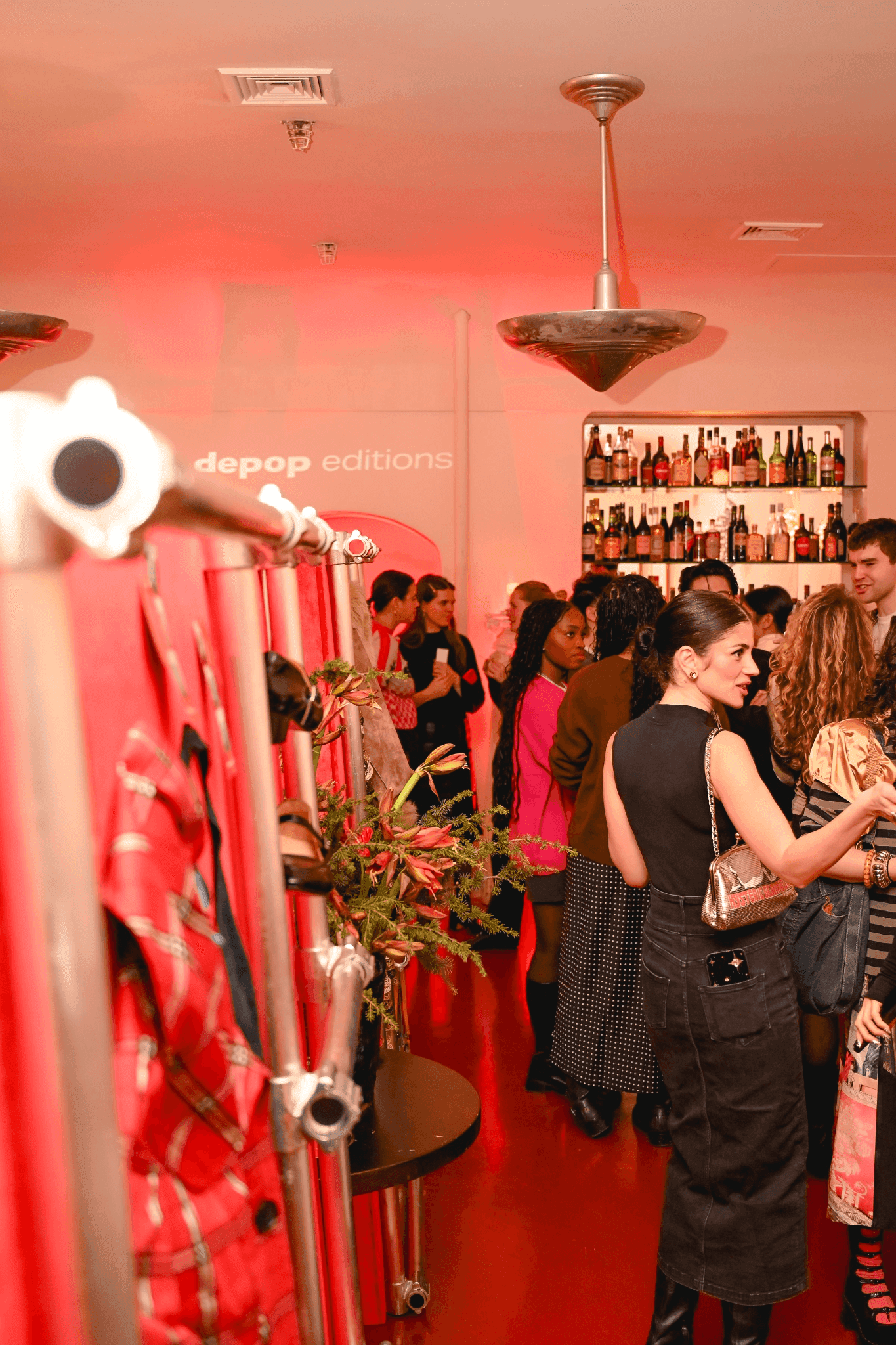 Guests exploring trend vignettes in a red-lit venue at Casino in Lower Manhattan.