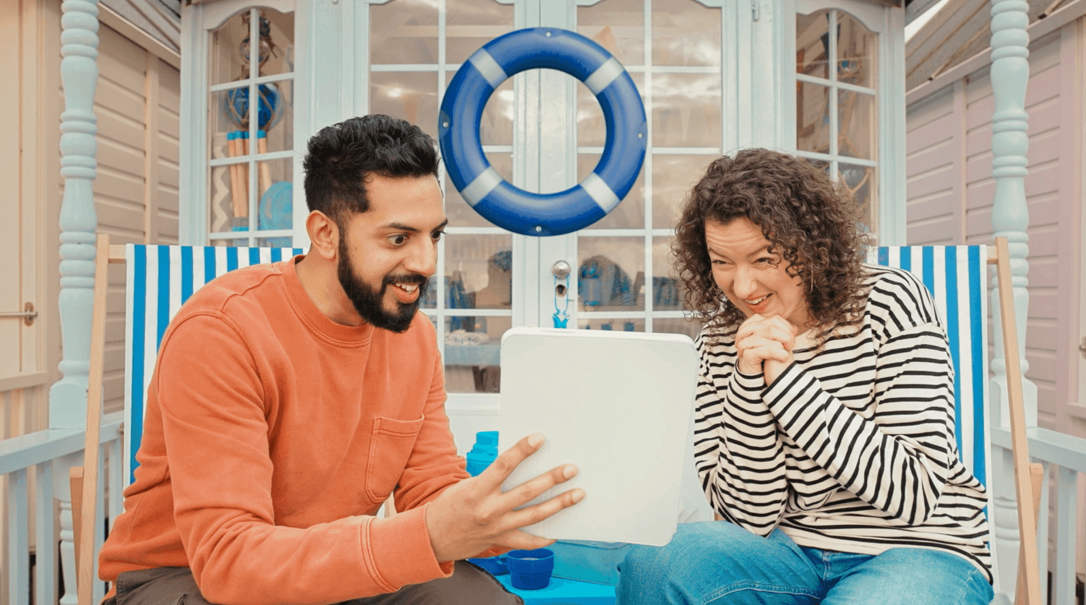 Man and woman looking at tablet excited